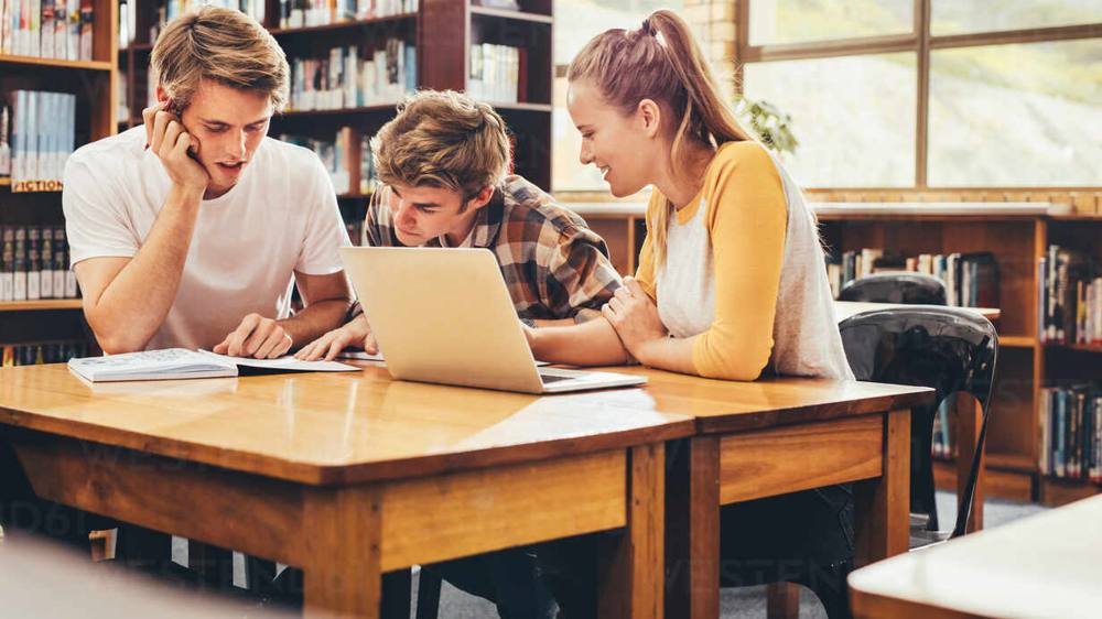 Student preparing for GMAT exam by writing notes, representing ESMT Berlin MiM GMAT preparation