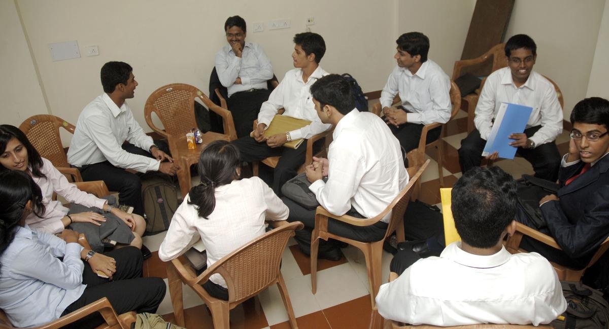 Nanyang MBA students networking and discussing career opportunities during placement preparation