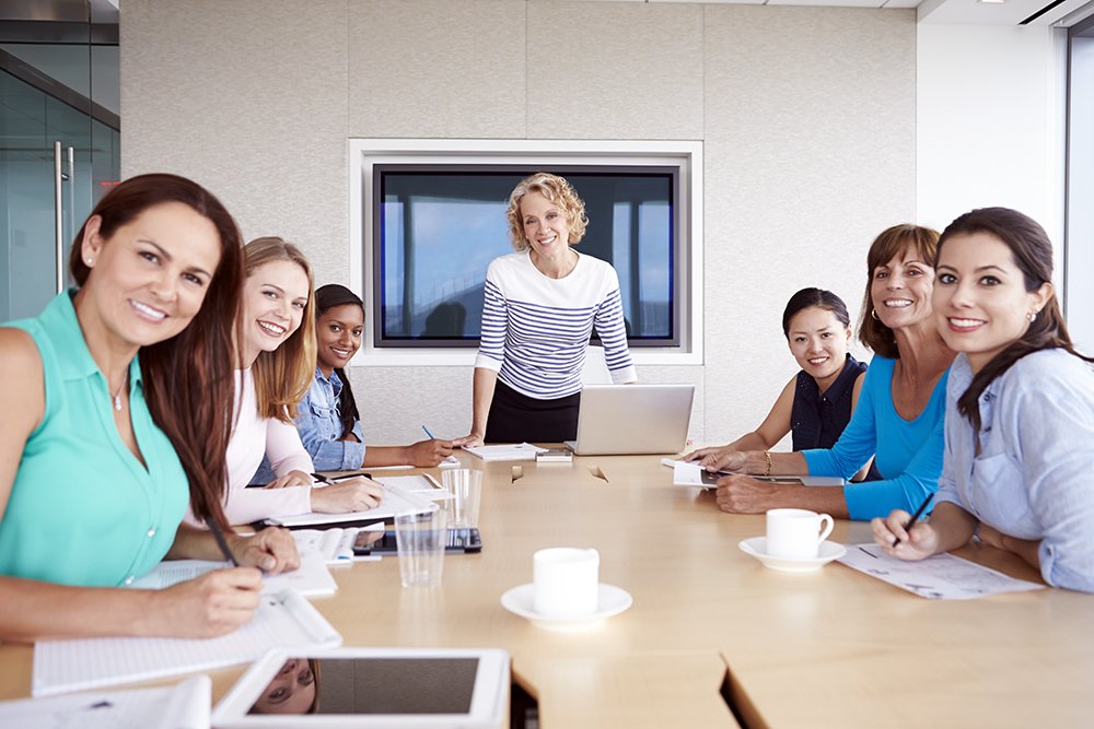 Kings College London MiM graduates in a professional business meeting discussing career roles
